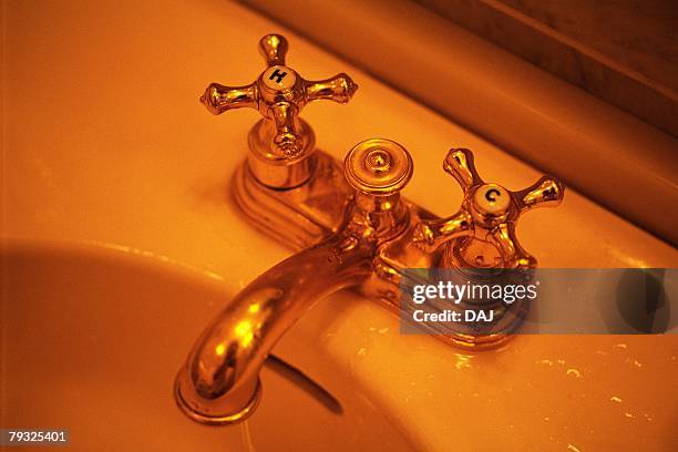 faucet on washbowl, high angle view, close up, toned image - wash bowl stock-fotos und bilder