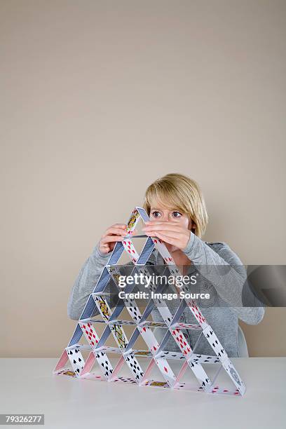 woman making a house of cards - house of cards stock pictures, royalty-free photos & images