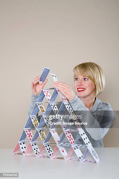 woman making a house of cards - house of cards stock pictures, royalty-free photos & images