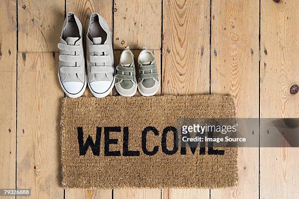training shoes and a welcome mat - welcome sign stock pictures, royalty-free photos & images