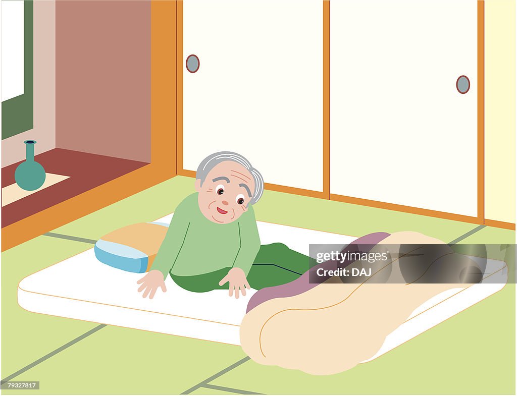 Senior man sitting on mattress, high angle view