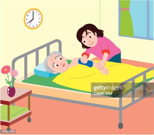 woman wiping arm of senior man lying on bed, high angle view - propped up pillow stock illustrations