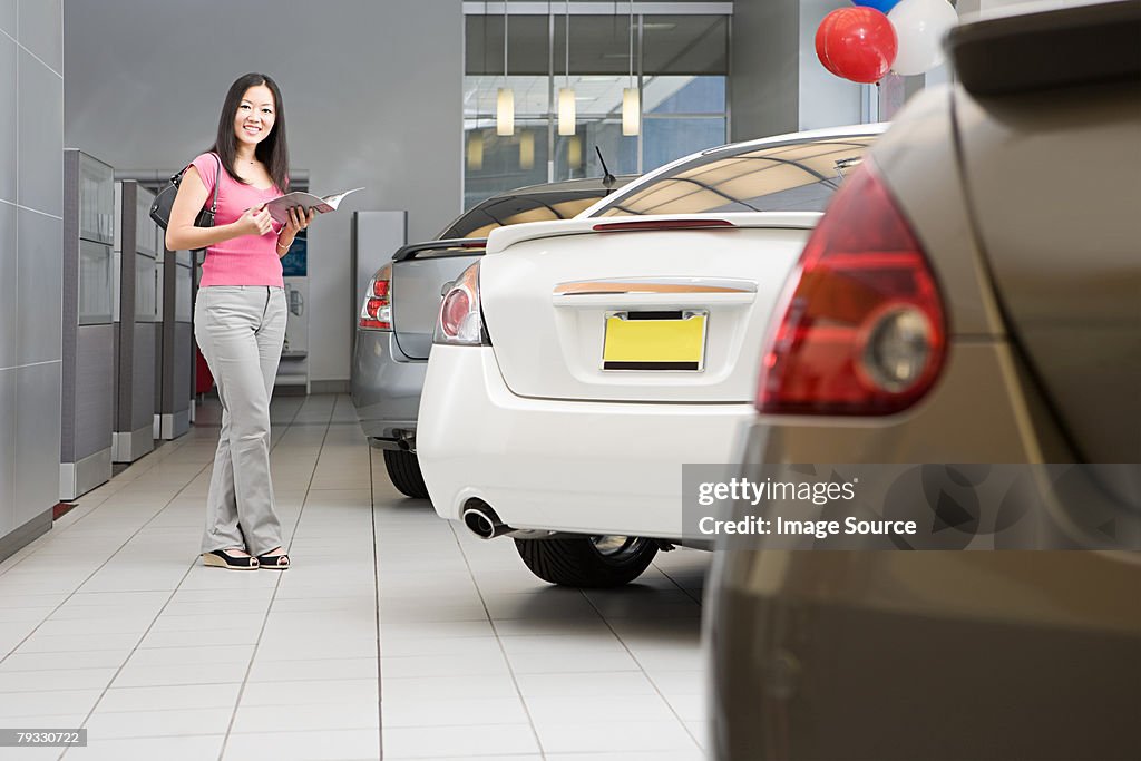 Woman in car dealership