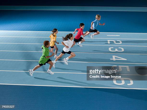 children running in race - boy running track stock pictures, royalty-free photos & images