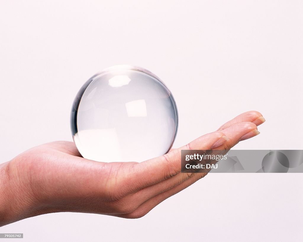 Image of Left Hand Holding a Crystal Ball, Side View