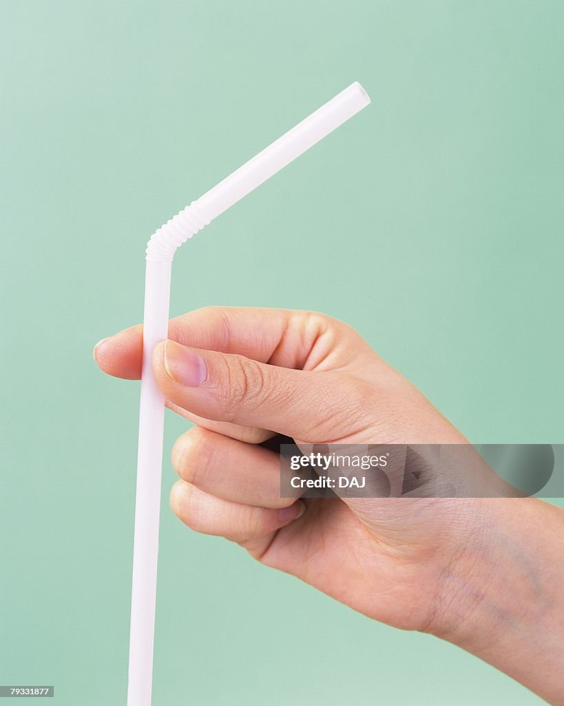 Image of Right Hand Holding a Straw, Side View