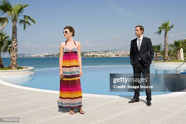 stylish couple by pool - poolside glamour stock pictures, royalty-free photos & images