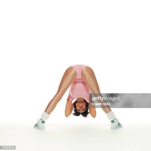 a woman in leotard exercising, rear view, copy space - leaning over stock-fotos und bilder