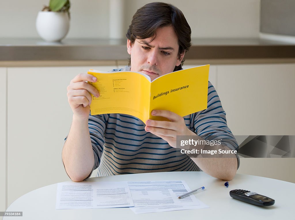 A man reading an insurance leaflet