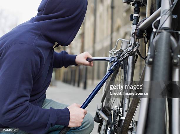 a thief stealing a bike - thief stock pictures, royalty-free photos & images