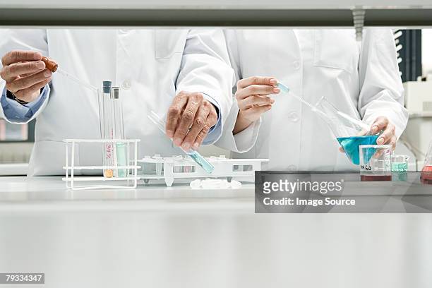 scientists conducting an experiment - chemistry stock pictures, royalty-free photos & images