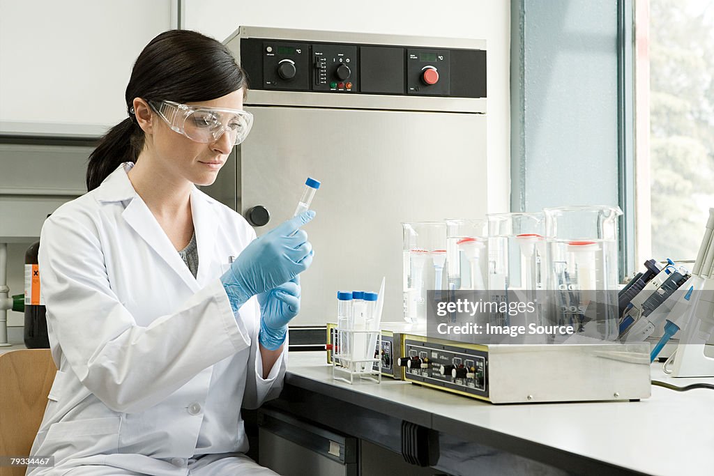 Tester Science A Scientist Inspecting A Test Tube High-Res Stock Photo - Getty Images