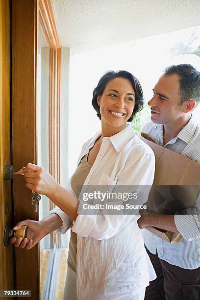 couple arriving home - man opening door woman bildbanksfoton och bilder