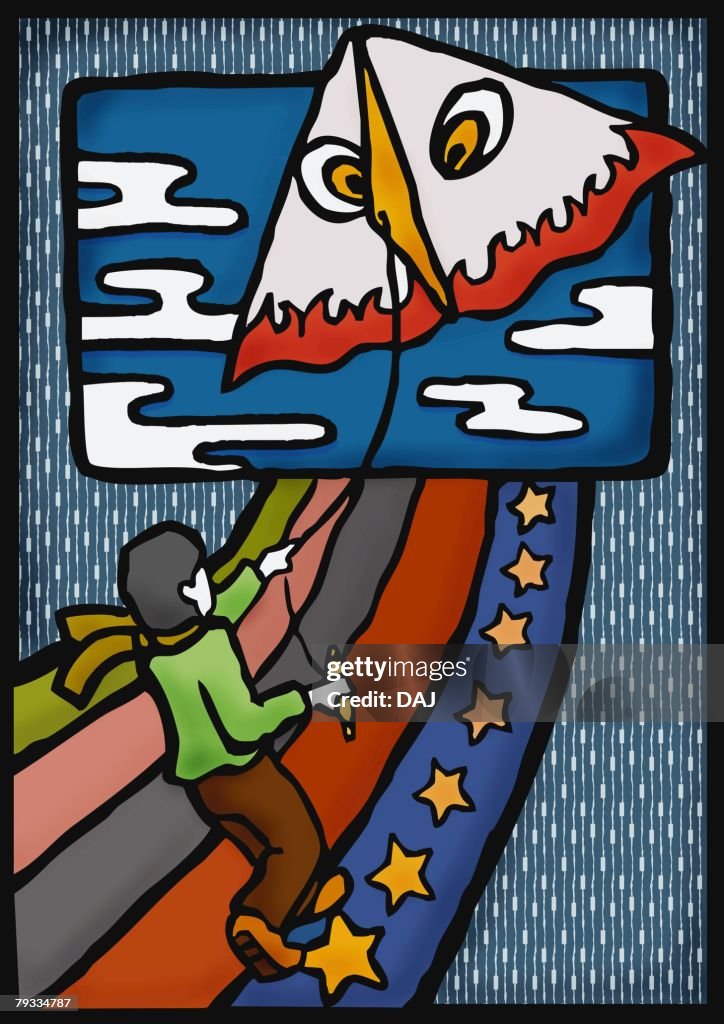 Boy flying a kite, rear view