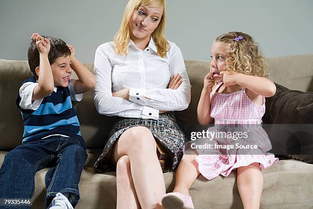 a mother annoyed at children pulling faces - power play stock pictures, royalty-free photos & images