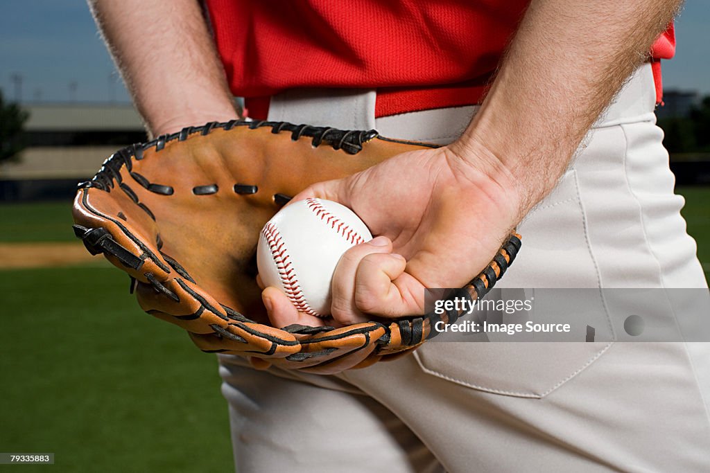 Baseball pitcher with glove and ball