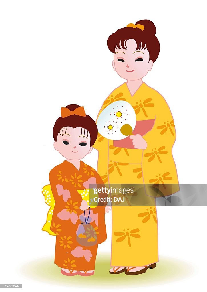 Two girls standing and smiling in Japanese style clothing, front view, Japan