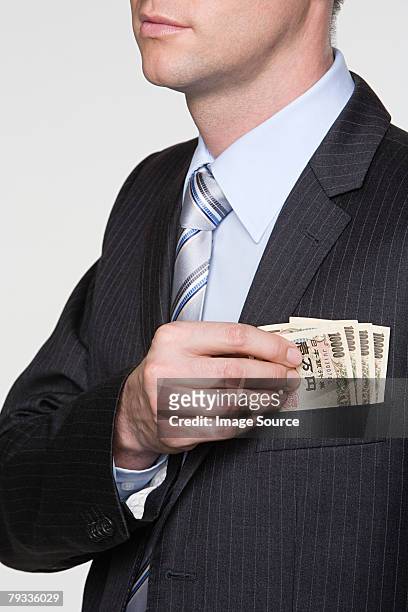 man with yen notes in his pocket - ten thousand yen note stock pictures, royalty-free photos & images