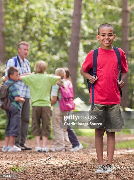 boy on a field trip - portrait of school children and female teacher in field stock pictures, royalty-free photos & images