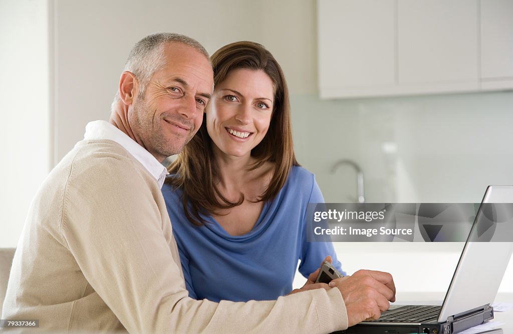 A couple paying bills online