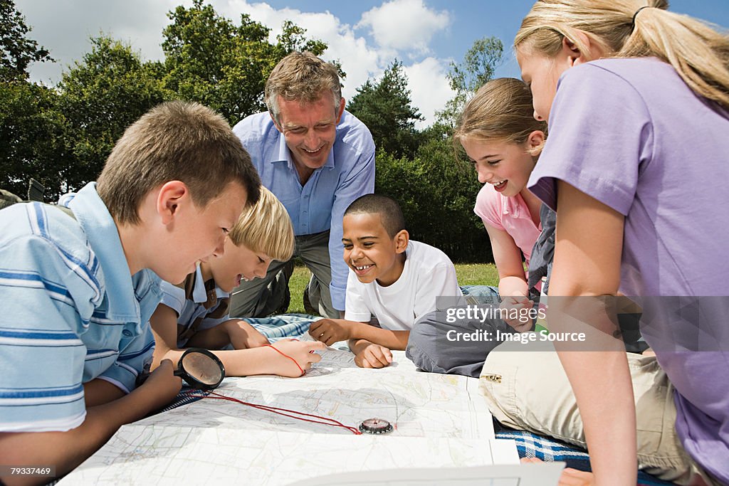 Teacher and pupils looking at map