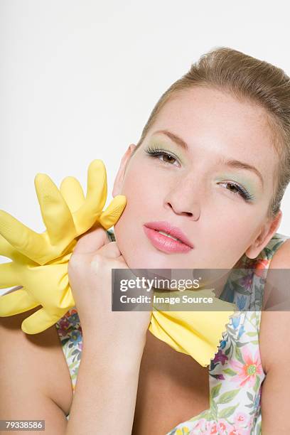 woman holding a pair of rubber gloves - bored housewife stock pictures, royalty-free photos & images