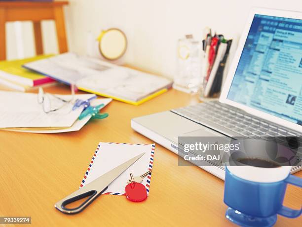 laptop and stationeries on desk - letter opener stock pictures, royalty-free photos & images