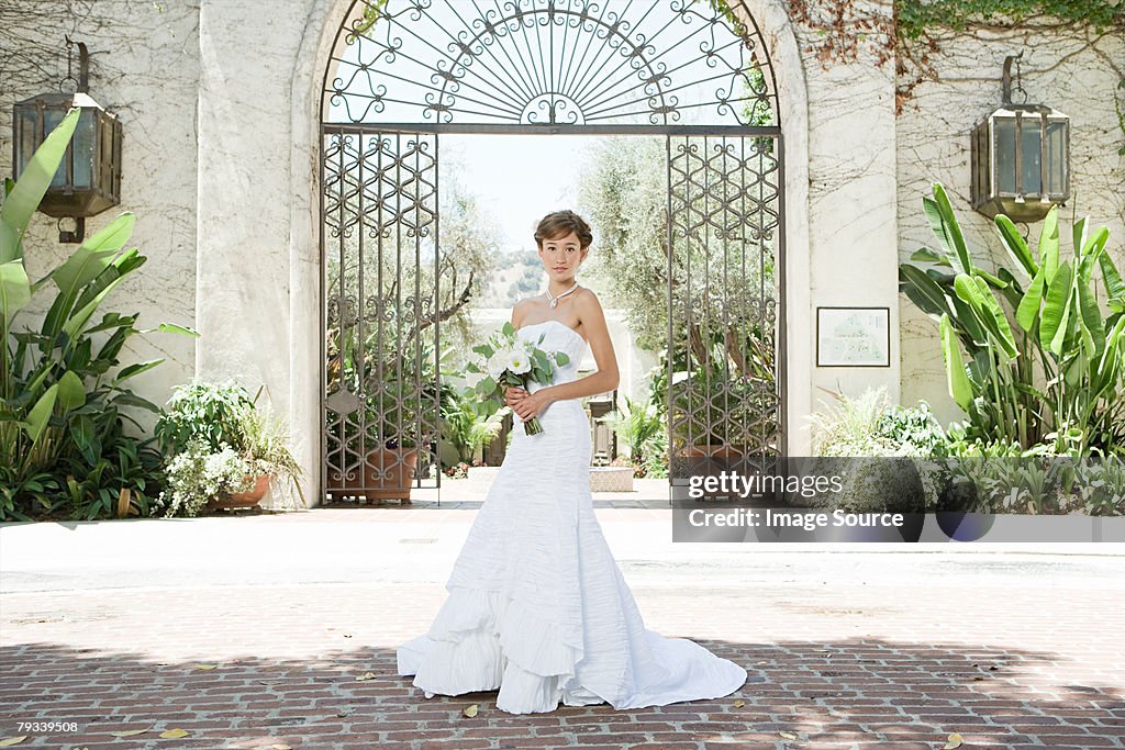 Bride standing in a courtyard