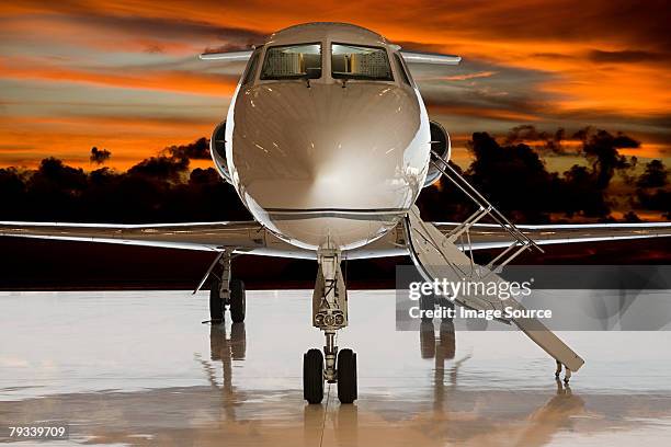 private airplane at sunset - private jet stockfoto's en -beelden