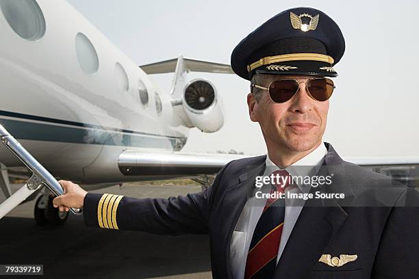 pilot by private airplane - hat and suit stock pictures, royalty-free photos & images