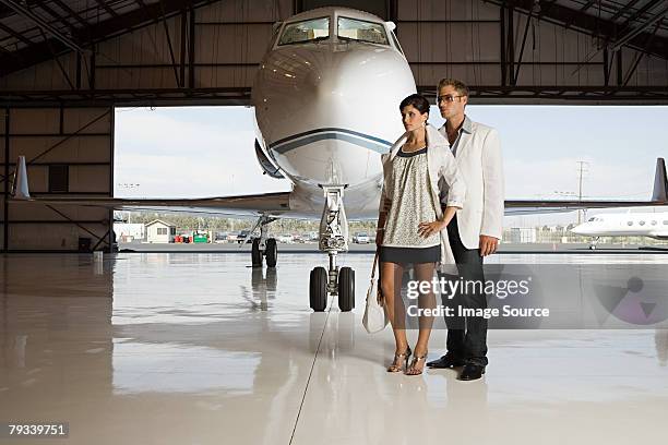 glamorous couple in hangar - high fashion stock-fotos und bilder
