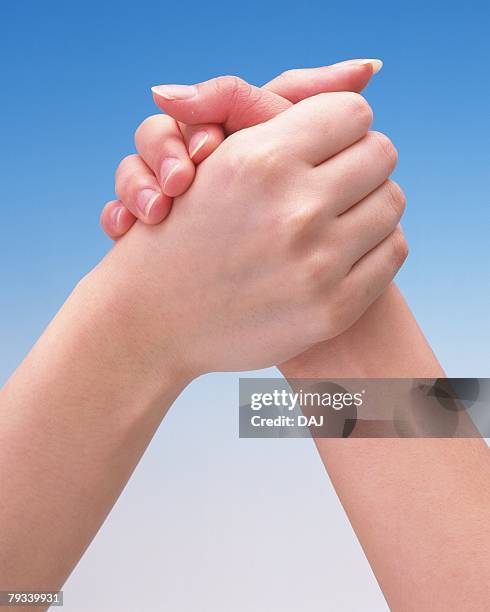 hands of two women arm-wrestling - arm wrestle stock pictures, royalty-free photos & images