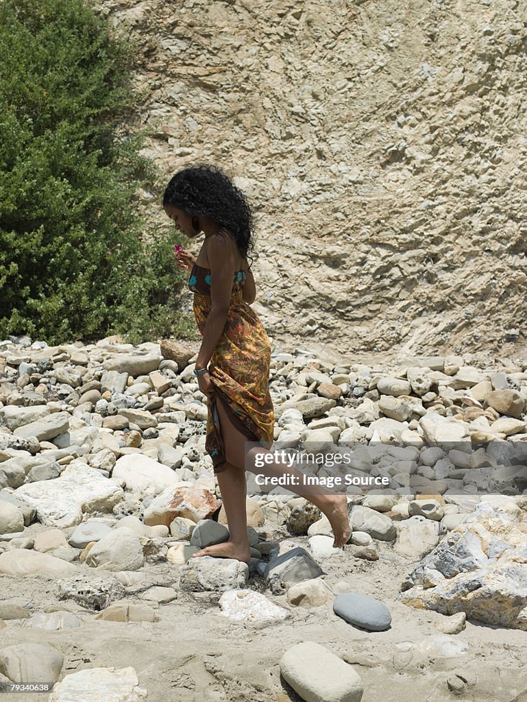 Young woman walking on rocks