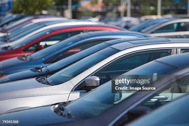 cars in parking lot - cars in a row stock pictures, royalty-free photos & images