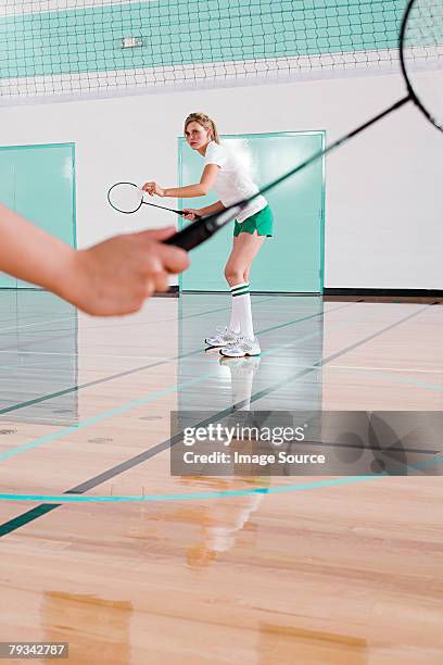 two women playing badminton - badminton stock pictures, royalty-free photos & images