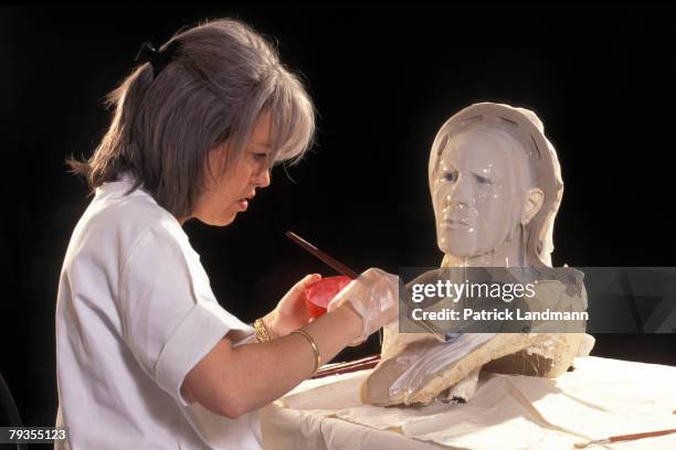 Anthropological sculptress Elisabeth Daynes uses the finished clay sculpture of Otzi's skull to make a contact-copy in white silicone with plaster...