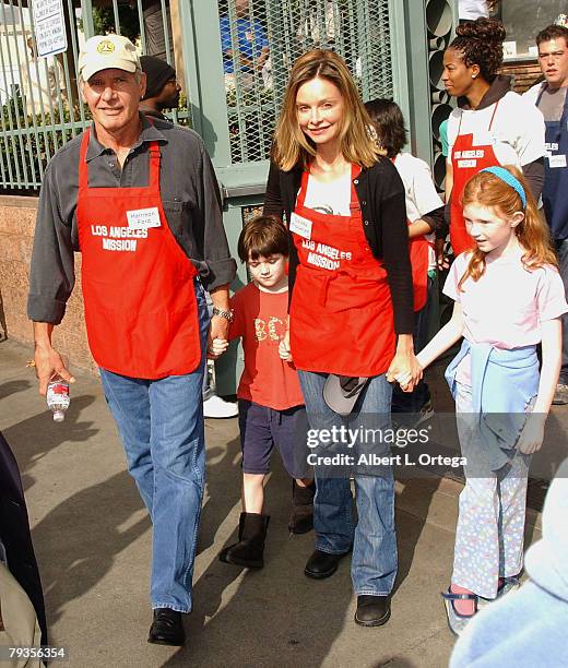 Actor Harrison Ford and actress Calista Flockhart with son Liam participate in serving Thanksgiving dinner to the Skid Row homeless at the Los...