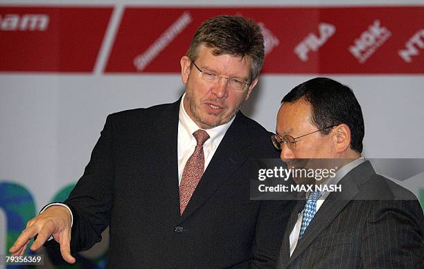 Honda's Motor Sports General Manager Yasuhiro Wada from Japan listens to his new Honda F1 team principal Ross Brawn at the launch of the F1 Honda...