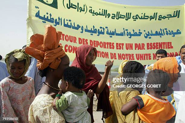 Negro-Mauritanian refugees mix with a welcoming party as they arrive in Rosso 29 January 2008. Almost two decades after ethnic conflict forced them...