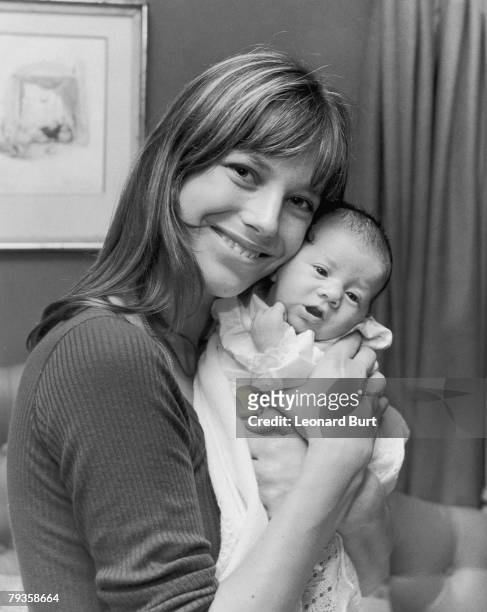 English actress and singer Jane Birkin with her new daughter Charlotte at their home in Cheyne Row, Chelsea, 12th August 1971. Charlotte's father is...