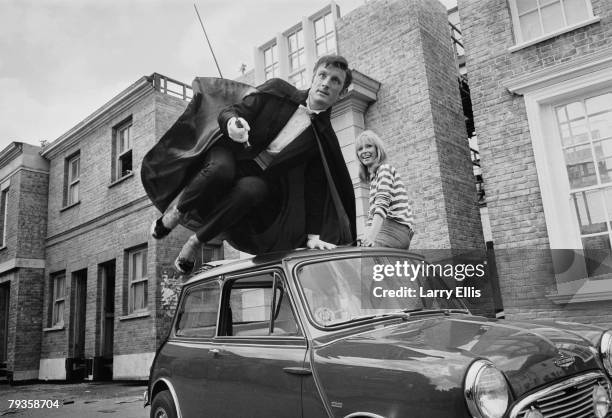 English actors Gerald Harper and Juliet Harmer in London during filming of the BBC adventure series 'Adam Adamant Lives!', 19th May 1966. Harper...