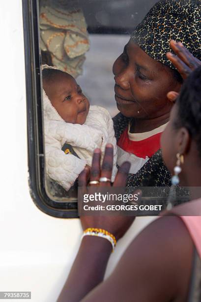 Negro-Mauritanian refugee and her infant are bid fairwell as they depart the refugee camp in Dagana Senegal to Rosso in Mauritania 29 January 2008....