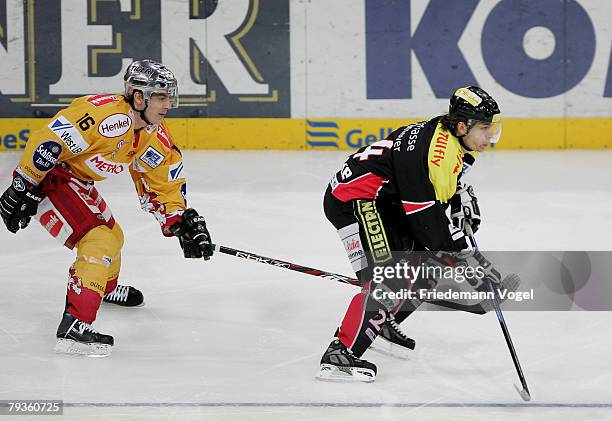 Rene Roethke of Hanover and Patrick Reimer of DEG fight for the puck during the DEL match between Hannover Scorpions and DEG Metro Stars at the TUI...