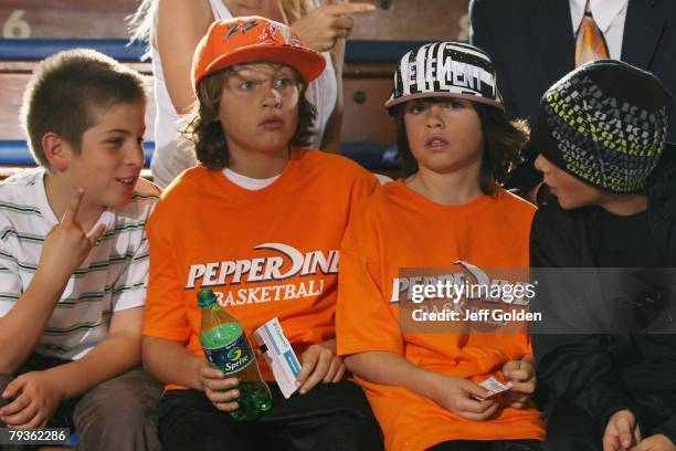 Actress Pamela Anderson's sons Brandon Thomas Lee and Dylan Jagger Lee sit with friends before the basketball game between the Loyola Marymount Lions...