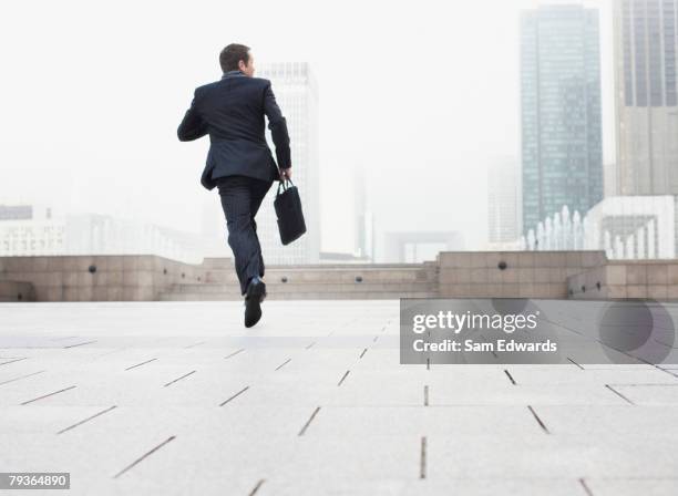 businessman outdoors jumping - businessman running back stock pictures, royalty-free photos & images
