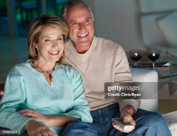 couple in living room watching television - watching tv couple night stock pictures, royalty-free photos & images