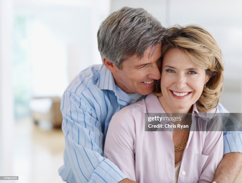 Couple in kitchen being affectionate