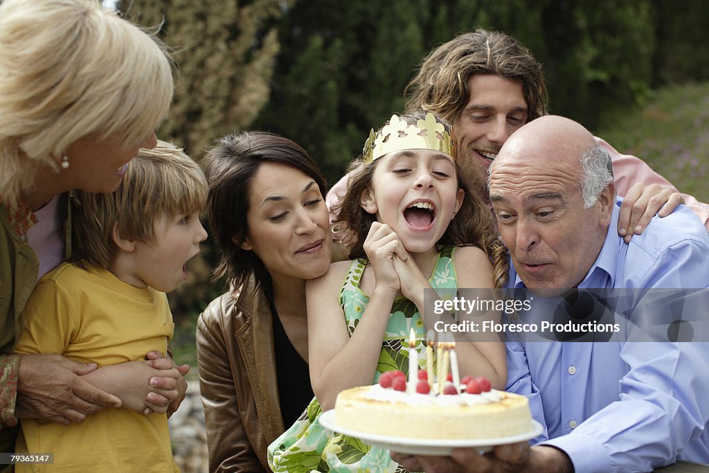 Young girl celebrating birthday with family