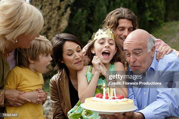 young girl celebrating birthday with family - girlfriends birthday stock pictures, royalty-free photos & images