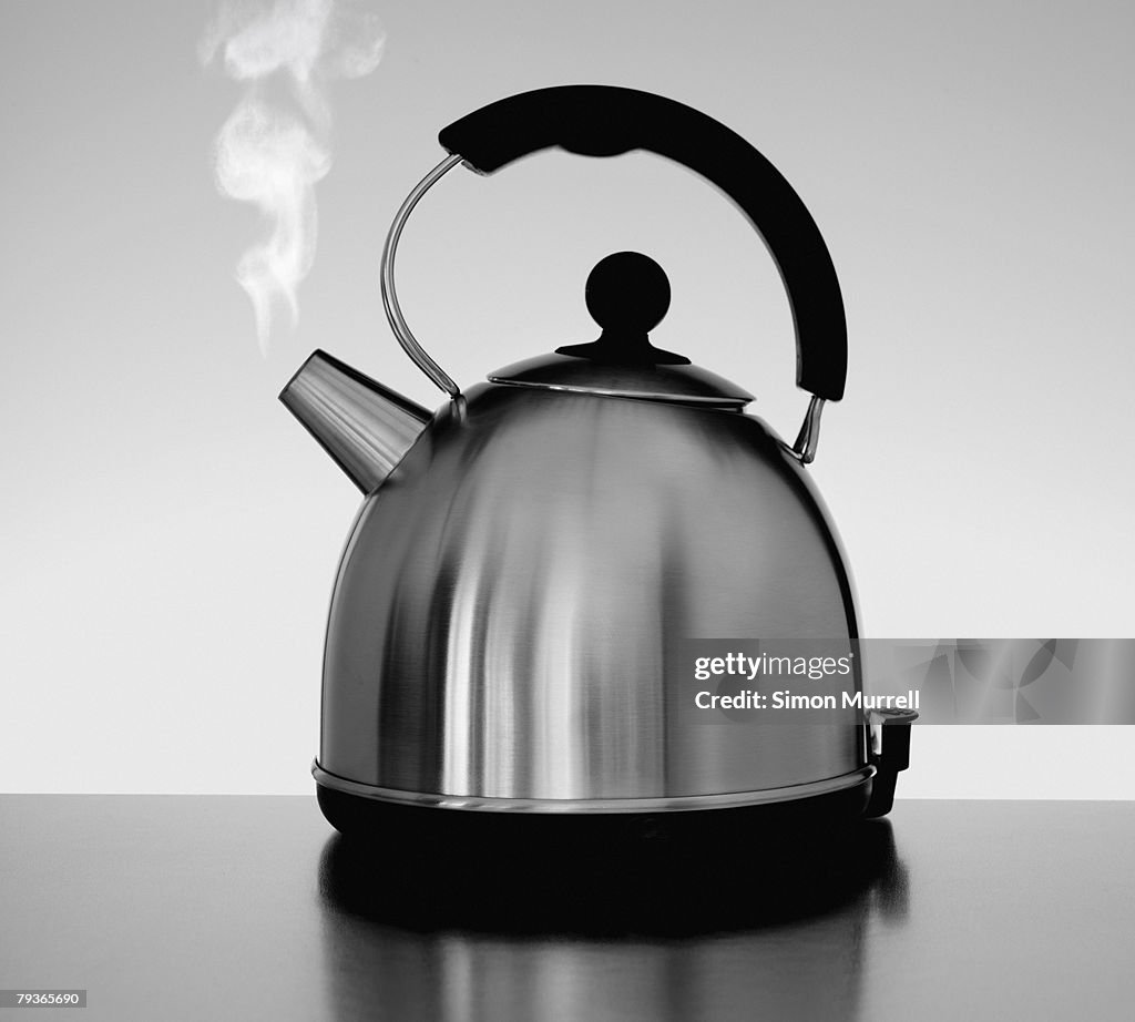 Tea kettle with steam indoors